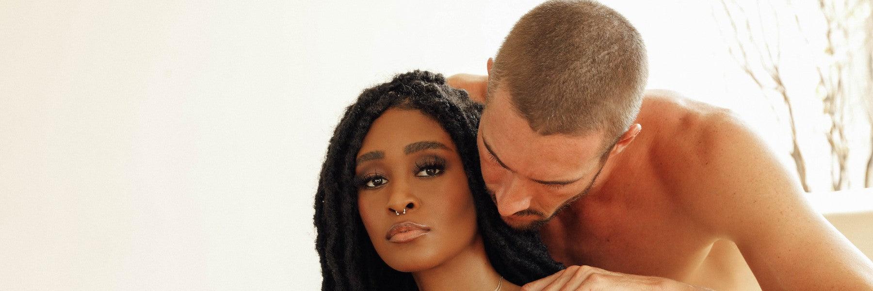 Intimate couple in soft lighting, featuring luxury lifestyle, for JIMMYJANE adult products.