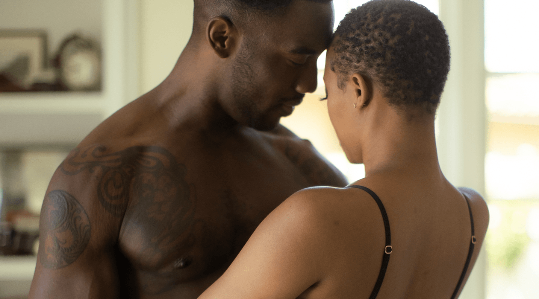 Intimate couple embracing in a softly lit room, luxury lifestyle concept from JIMMYJANE®