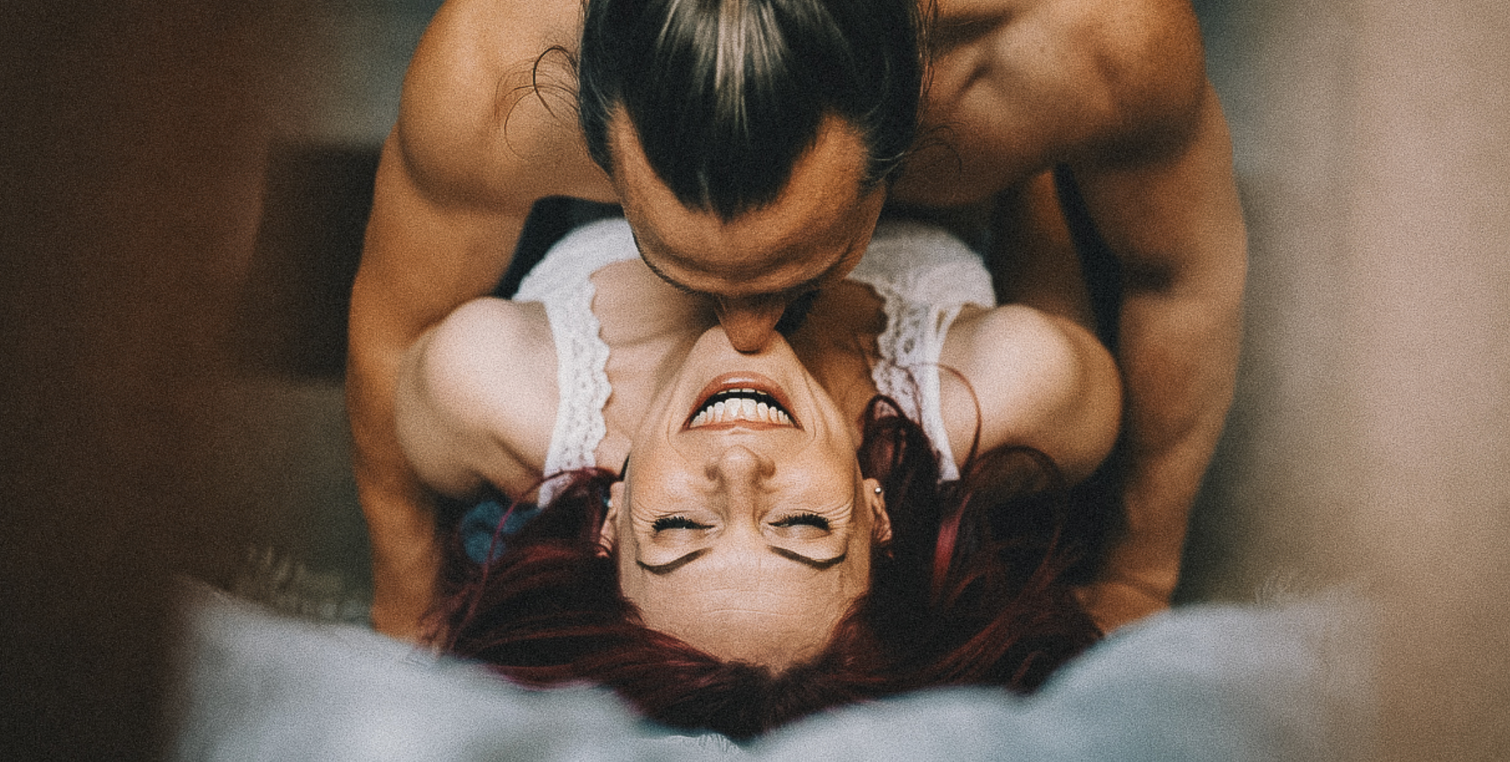 Couple laughing in bed together