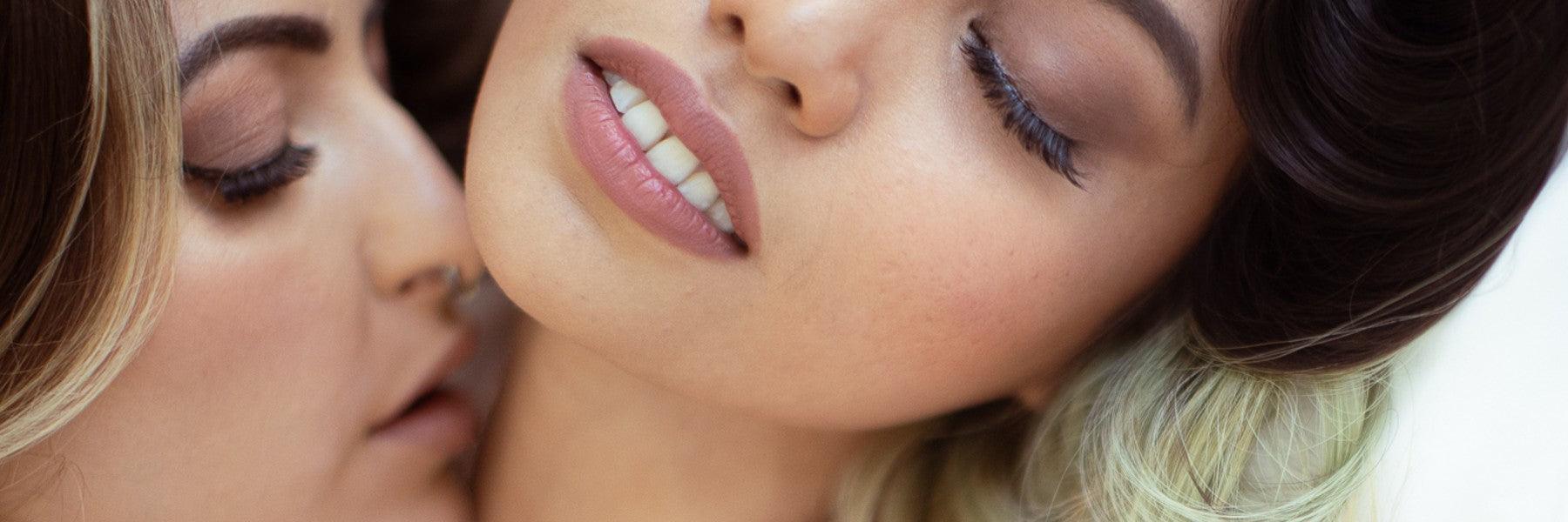 Close-up of two women with closed eyes in an intimate moment, promoting JIMMYJANE luxury lifestyle.