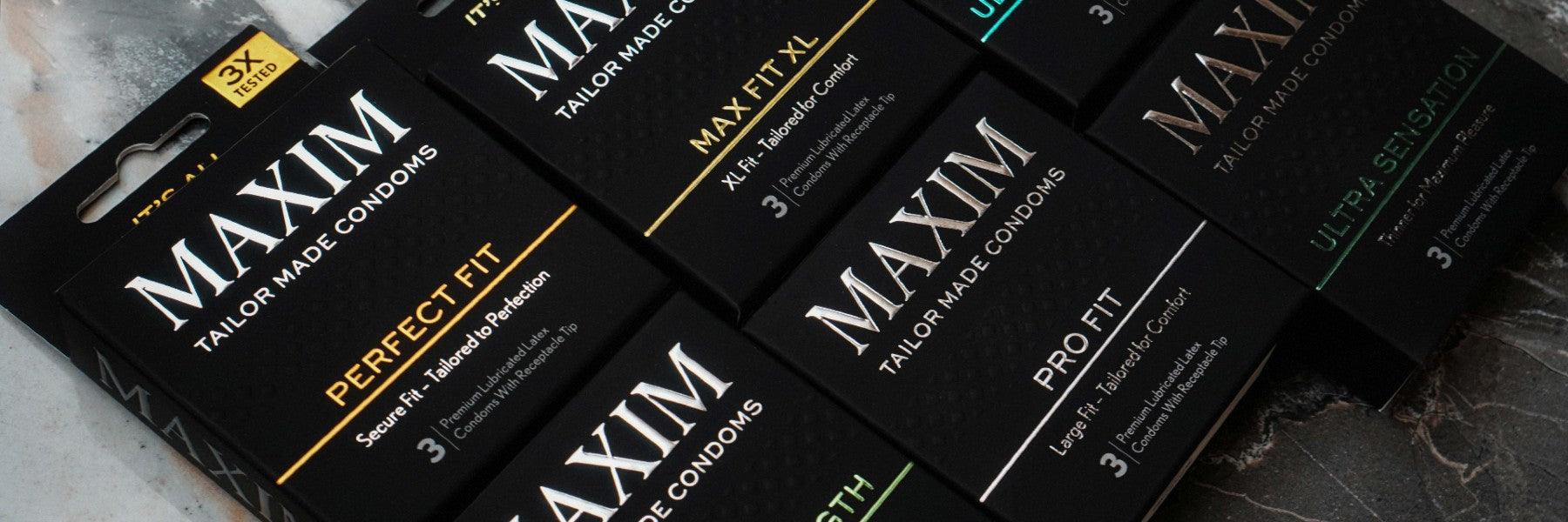 MAXIM tailor made condom boxes in assorted types on a marble surface, luxury adult products
