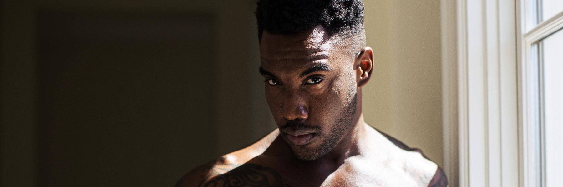 Confident shirtless man with tattoo by sunlit window, luxury lifestyle, JIMMYJANE homepage