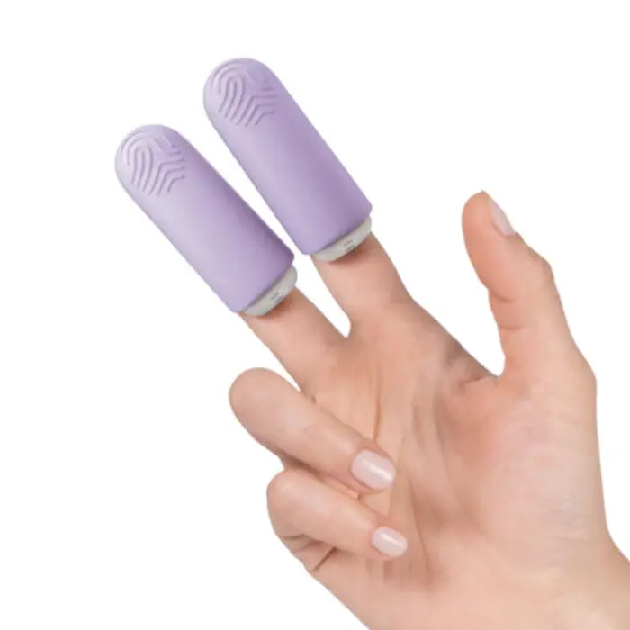 Hand wearing two lavender finger massagers from JIMMYJANE, luxury wellness accessory