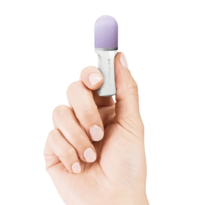 Hand holding a JIMMYJANE luxury mini massager with a purple tip on white background