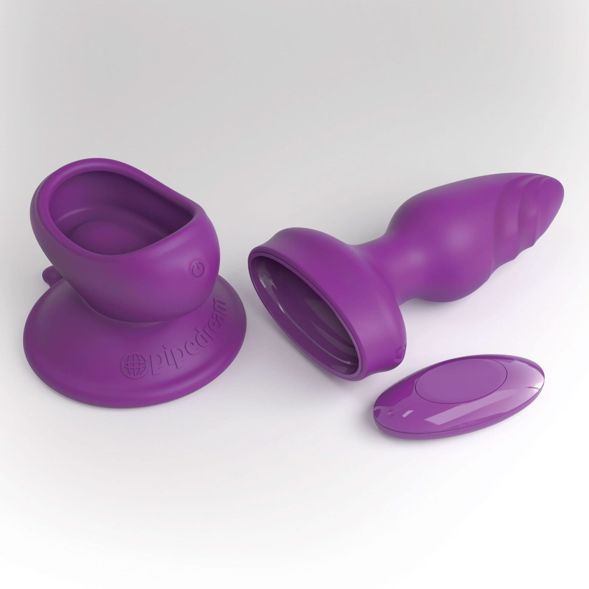 The 3Some Pipedream® Wall Banger Plug is a purple silicone adult toy with a vibrating massager, remote control, and sturdy suction cup base, shown on a white background.