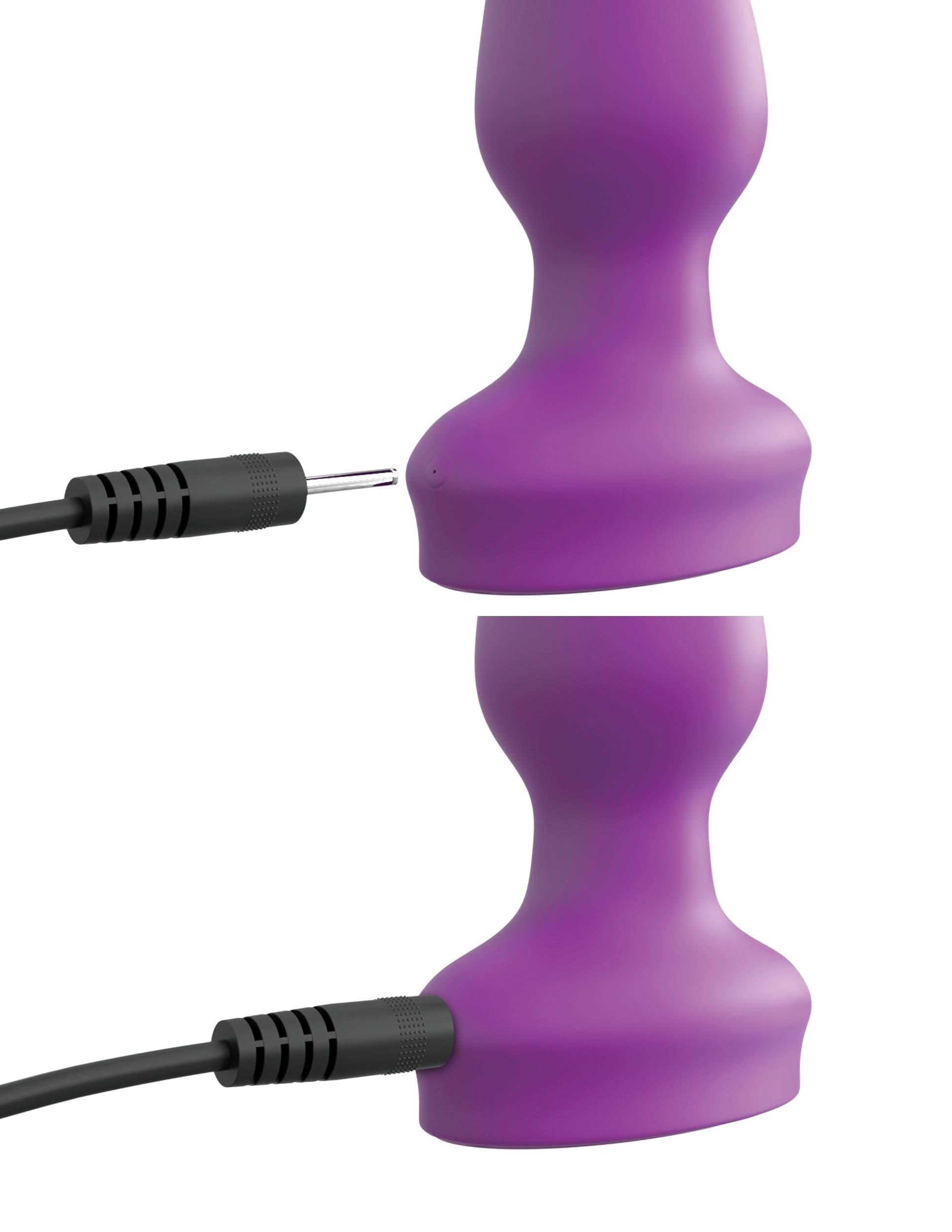 The 3Some Pipedream® Wall Banger Plug, a purple silicone plug with a charging port and suction cup base for hands-free use, is displayed before and after being connected to its charging cable.