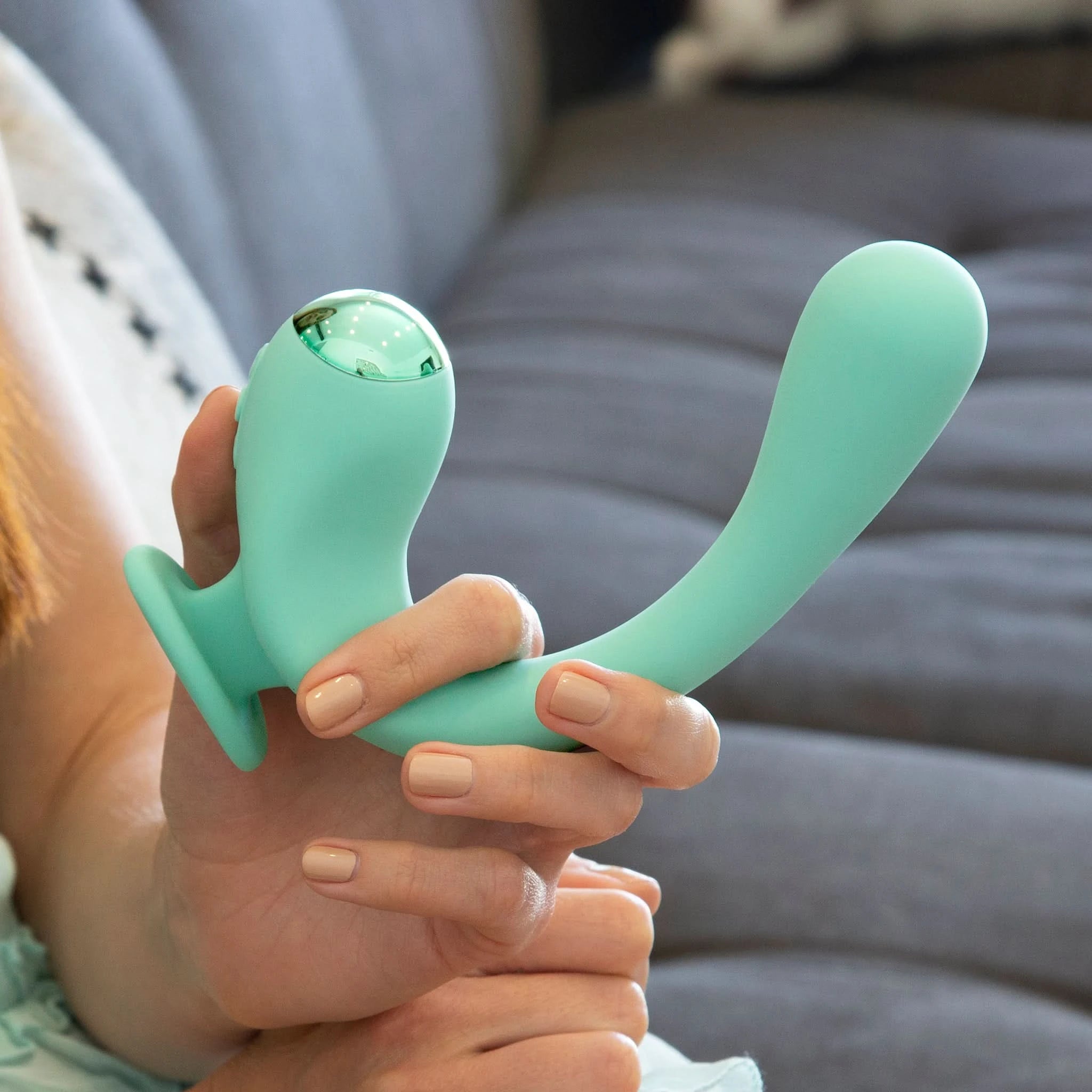 Model holding the Teal finger rabbit reflexx vibrator