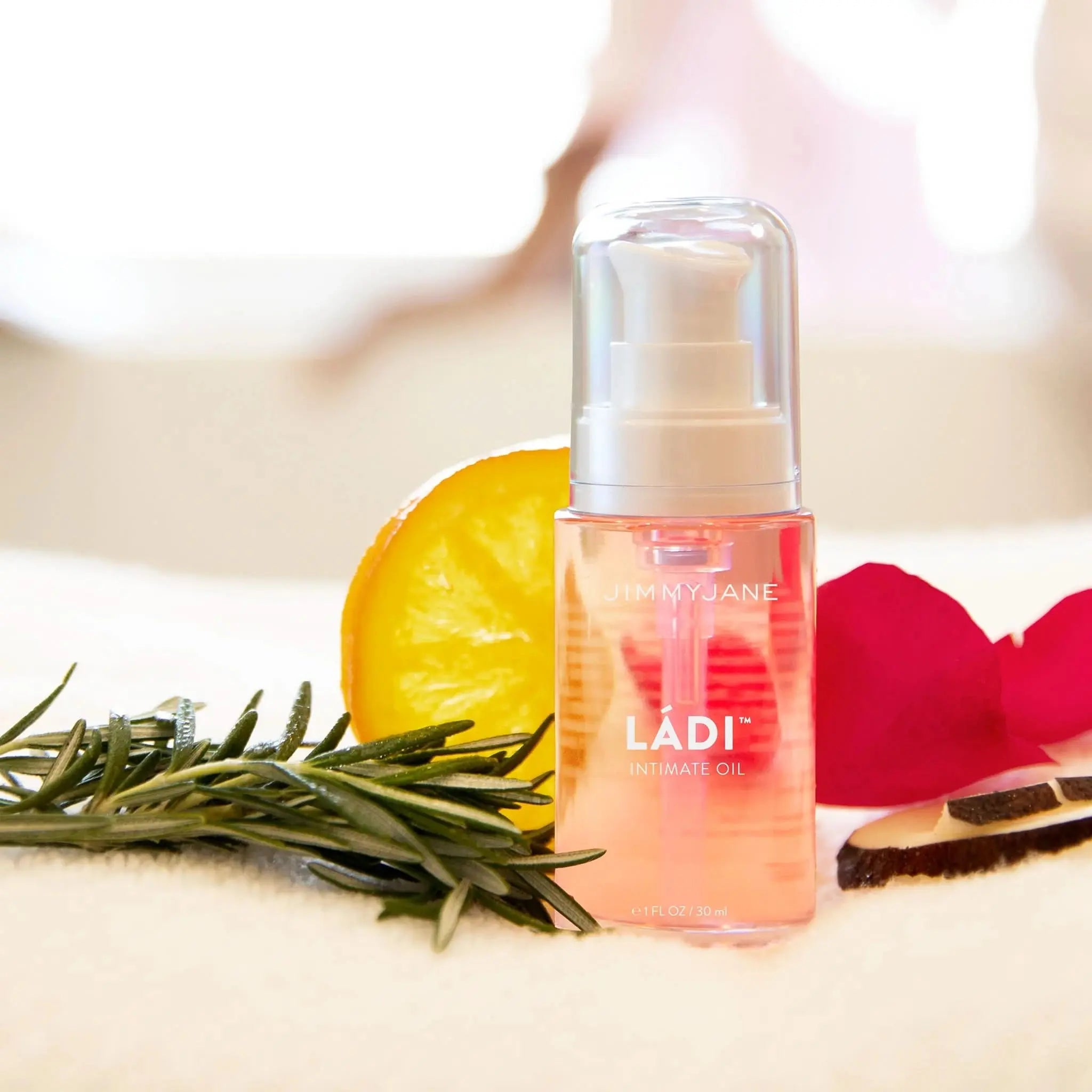 JIMMYJANE LÁDI Intimate Oil with orange slice, rosemary, rose petals, and wood on soft fabric