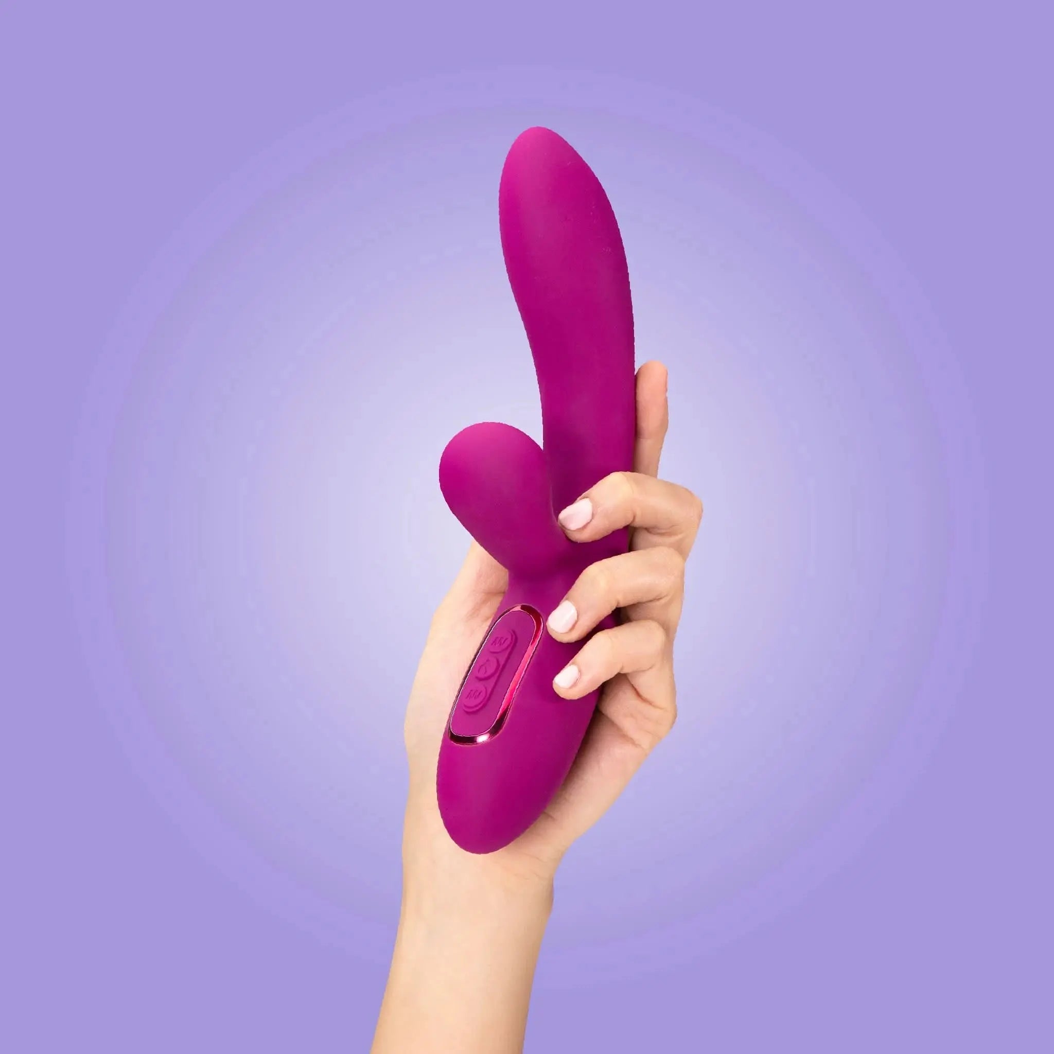 Hand holding a purple luxury personal massager from JIMMYJANE against a light purple background