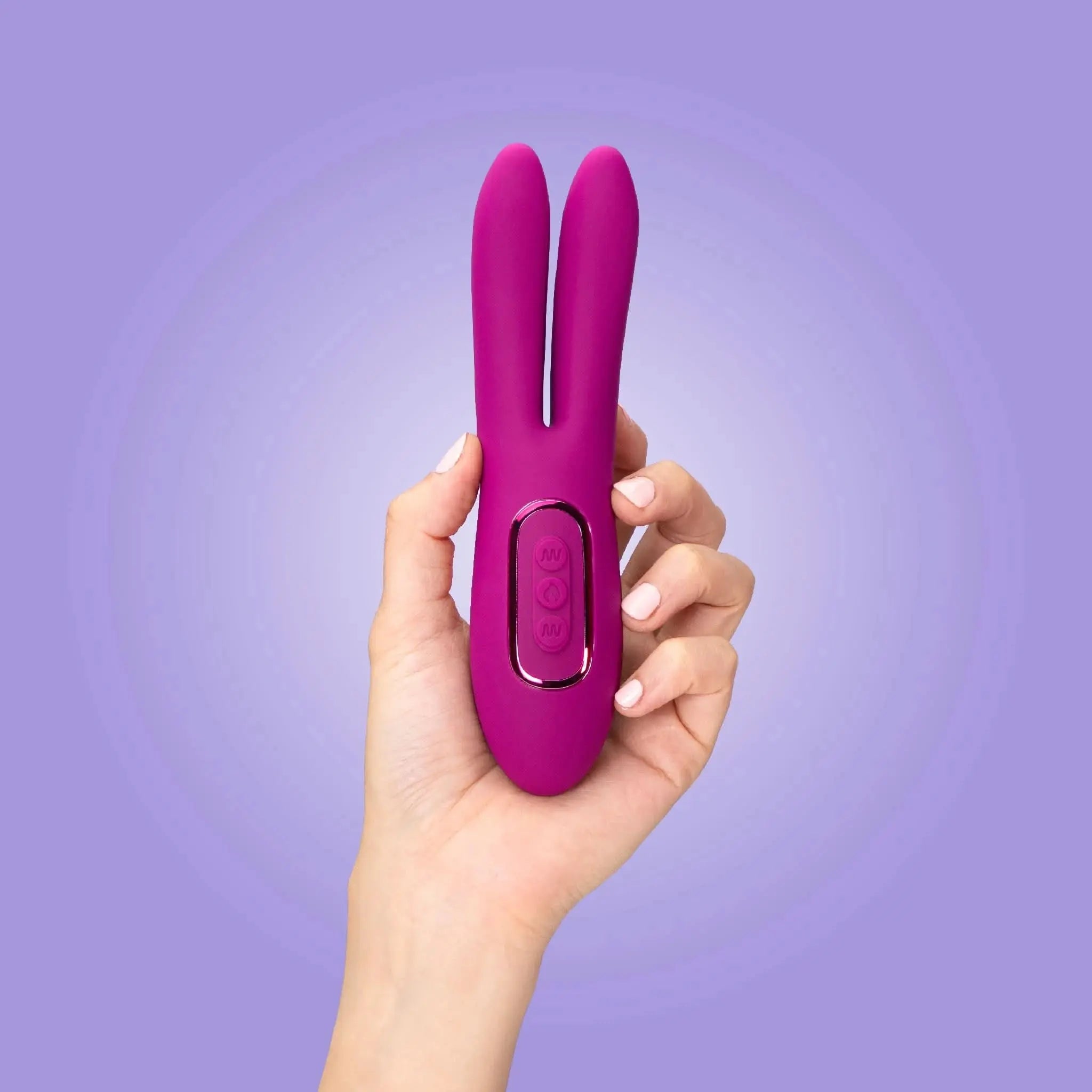 Hand holding a purple JIMMYJANE luxury dual-ended massager against a light purple background