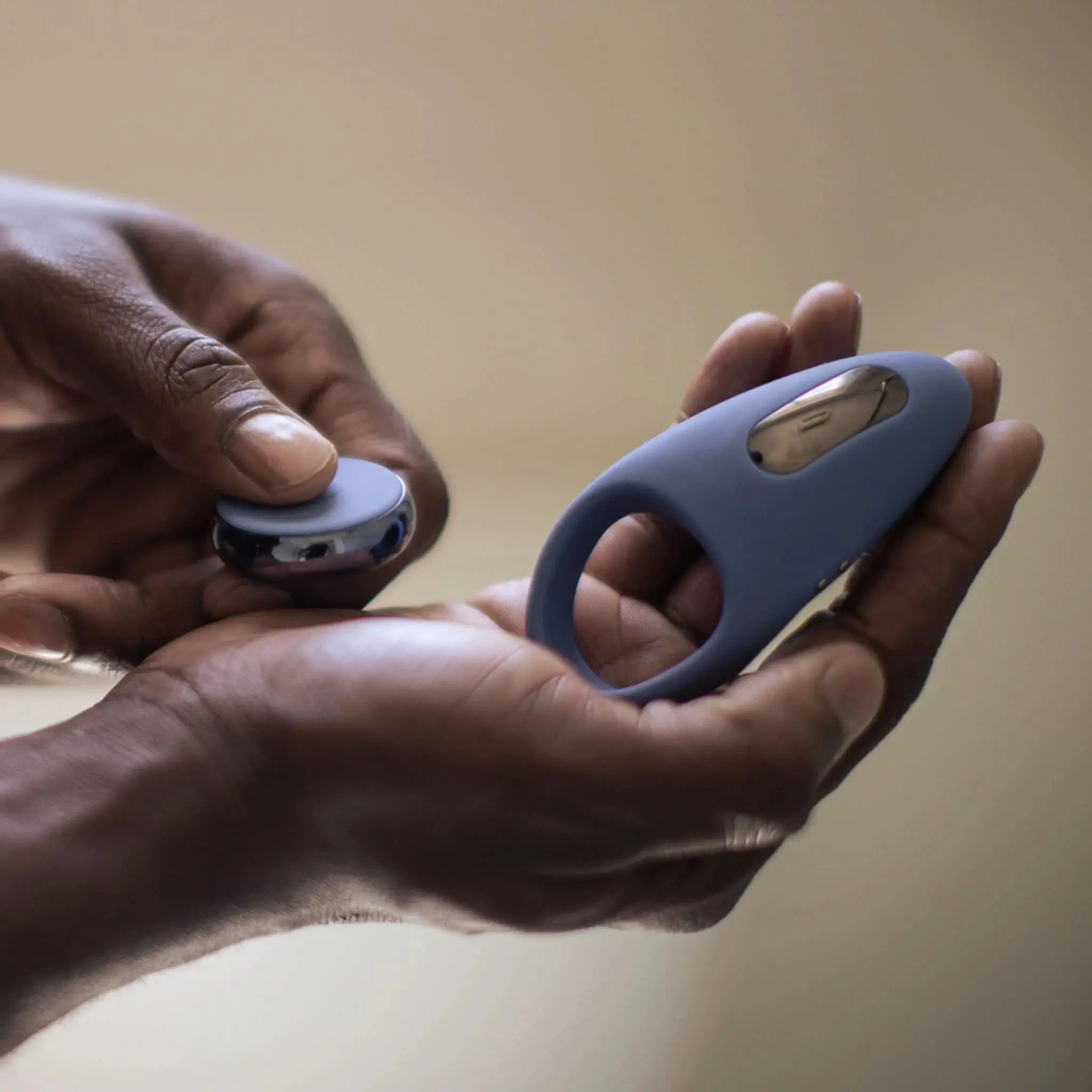 Hand holding a blue luxury silicone ring device from JIMMYJANE with silver metal accent