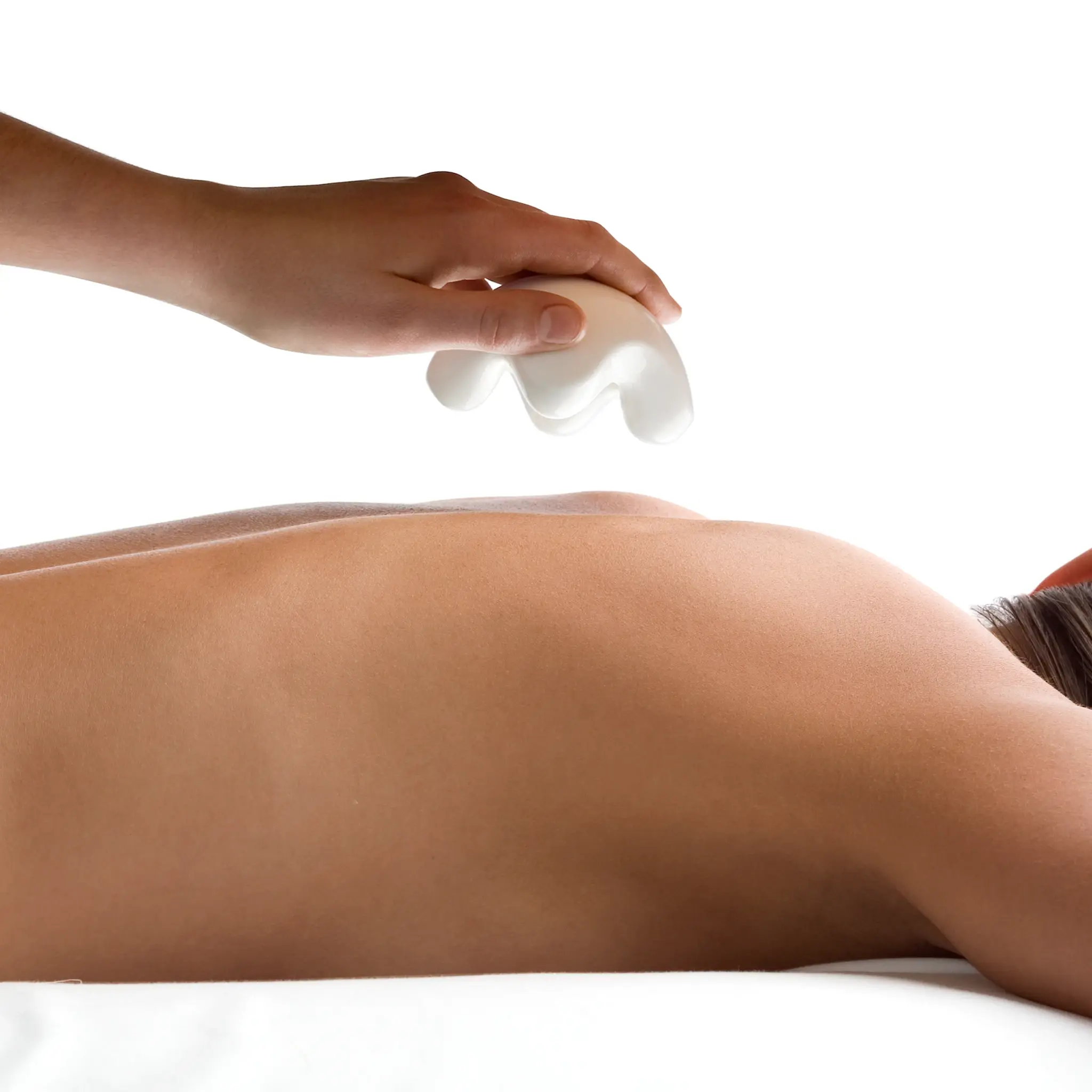 Hand using JIMMYJANE luxury white massage tool on bare back against white background