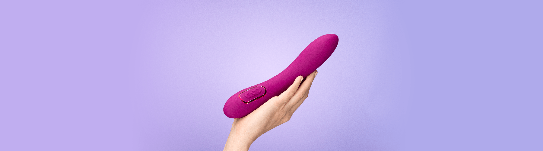 Hand holding a purple luxury massager by JIMMYJANE® on a lavender background