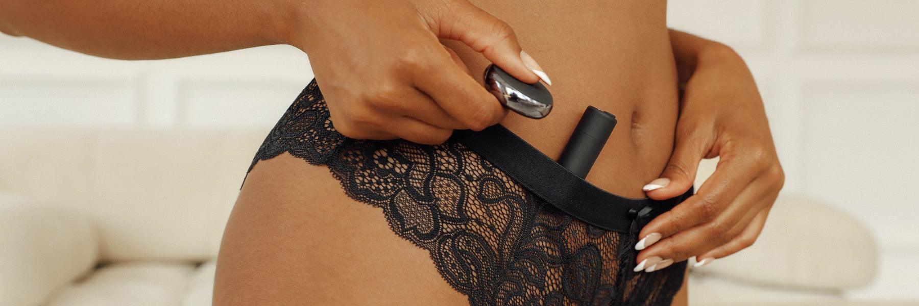 Closeup of a woman in lace underwear holding luxury personal massagers by JIMMYJANE.