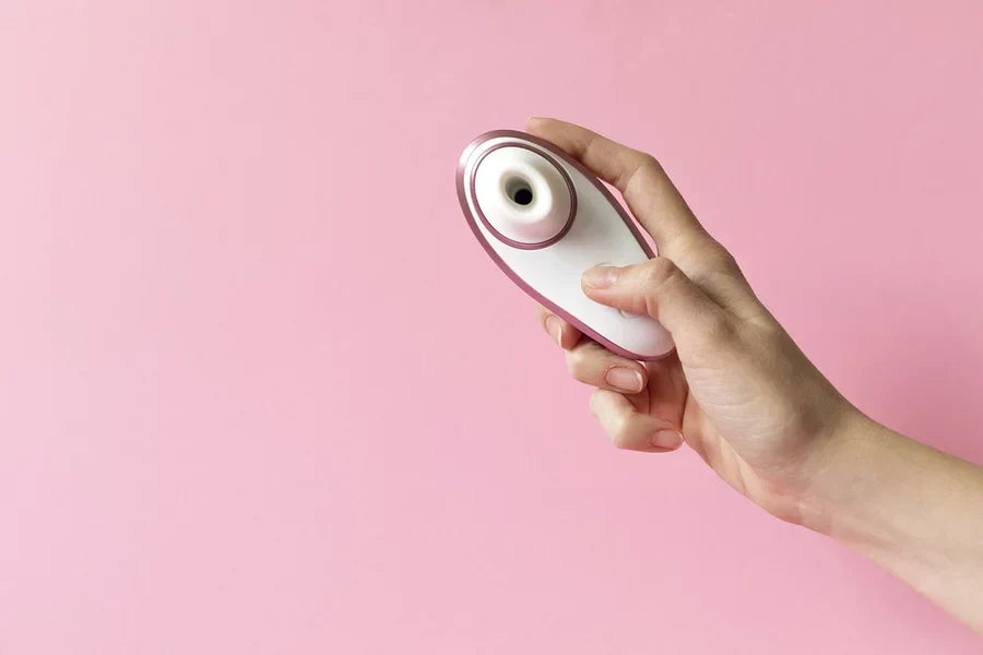 Person holding a clit vibrator with suction abilities