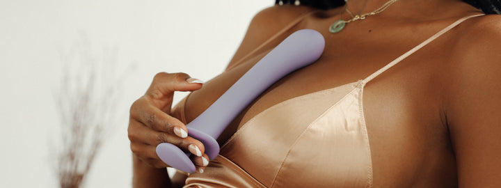 model holding a silicone dildo
