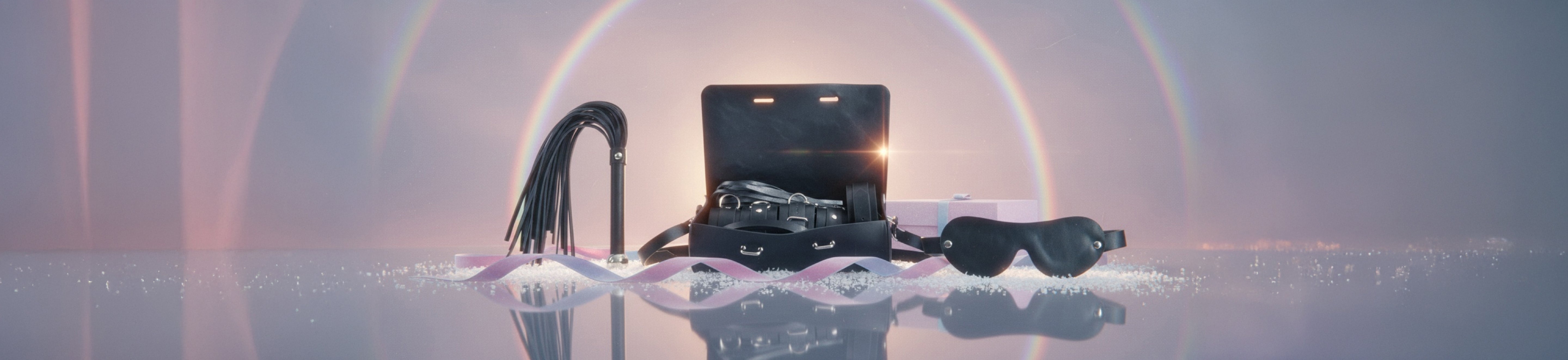 Black electronic device with cables on a reflective surface with a circular light effect in the background