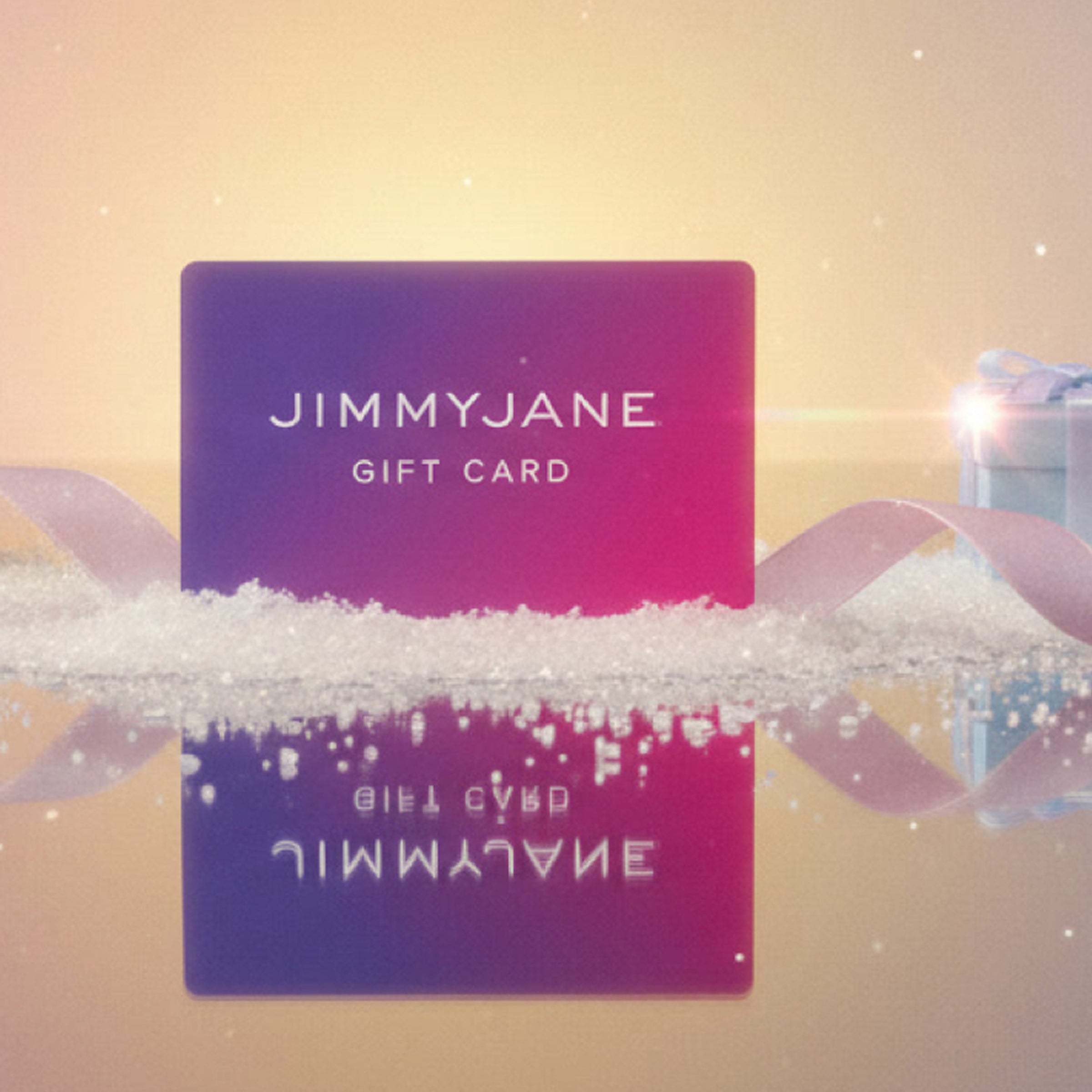 Jimmyjane gift card with a decorative ribbon on a soft focus background
