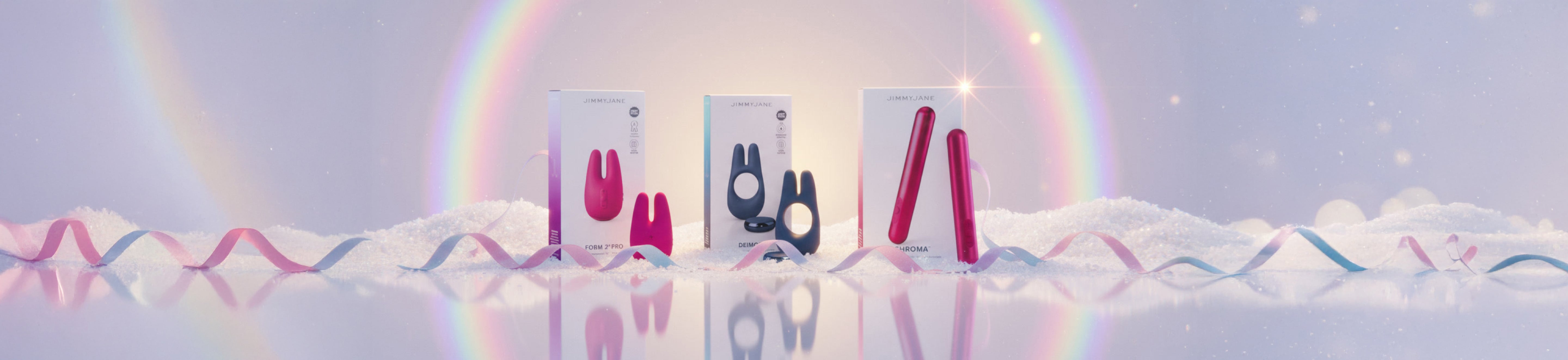 Three rectangular products with colorful designs on a reflective surface with a rainbow in the background.