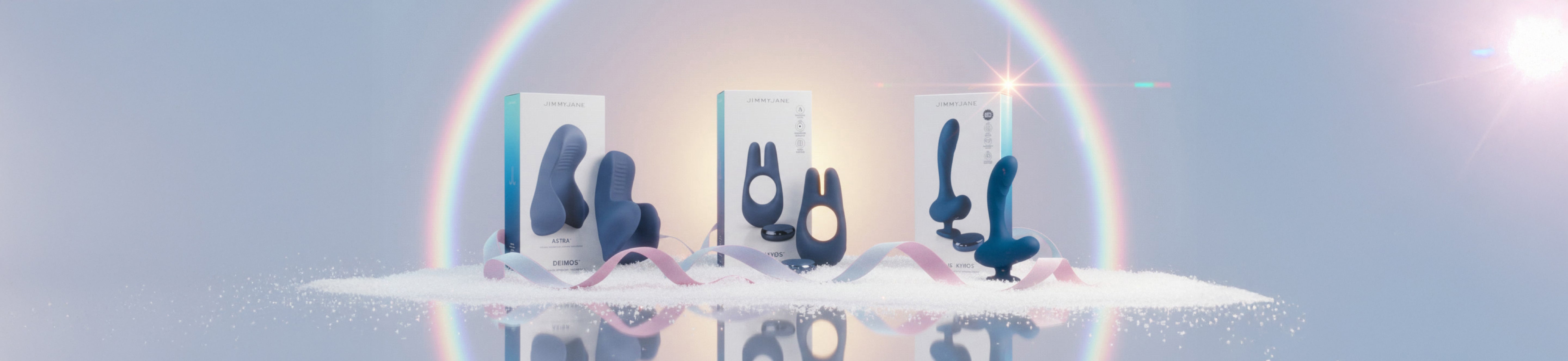 Three abstract sculptures on a reflective surface with a rainbow arch in the background