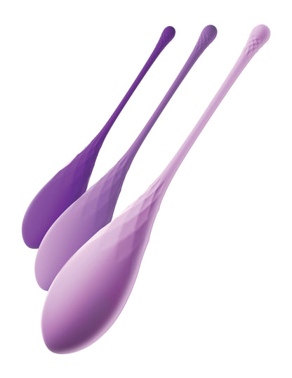 Three purple silicone spoons, resembling the Fantasy® For Her Pipedream® Kegel Train-Her Set, are arranged diagonally on a white background.