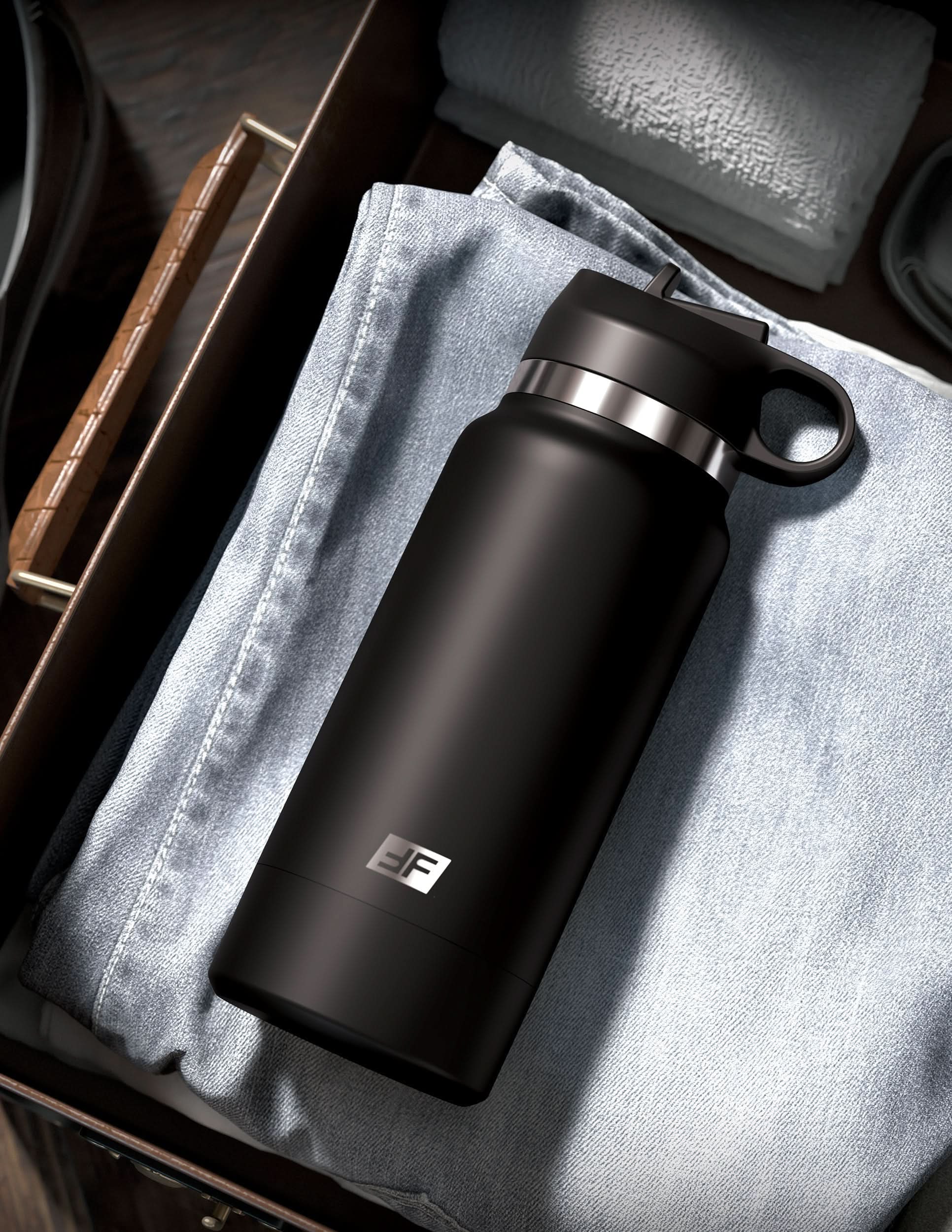 A PDX® Plus Fap Flask – Thrill Seeker, in black, sits discreetly on folded blue jeans in a drawer.