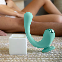 Teal finger rabbit reflexx vibrator Leaning against Afterglow candle