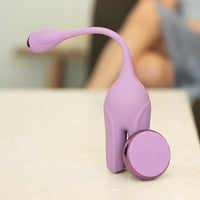 Vibrating dual motor kegel trainer with remote sitting on table