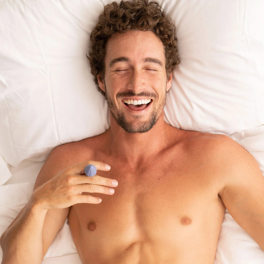 Male Model holding 1 inch silicone butt plug midnight blue ERSA