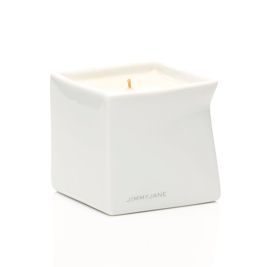 Santal scented Afterglow massage oil candle sitting on table