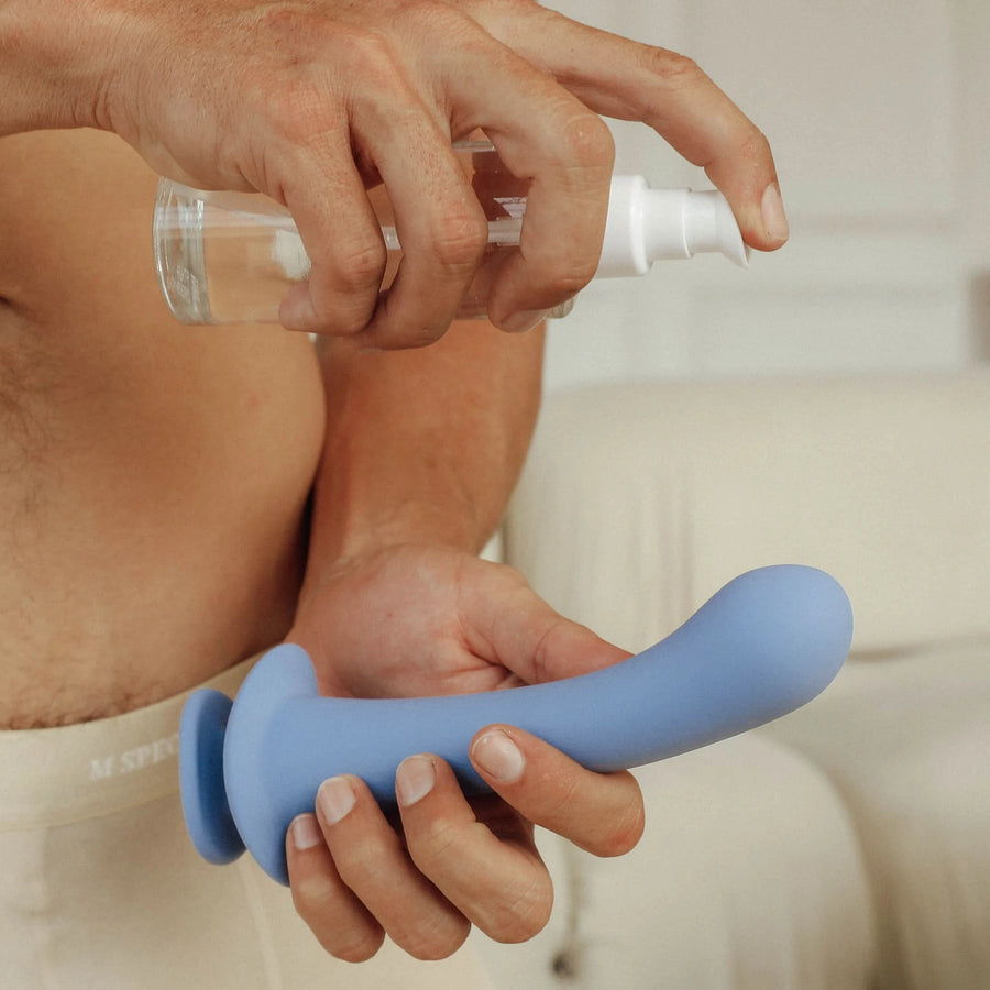 Male model holding a bottle of FDA cleared water-based sensation lubricant
