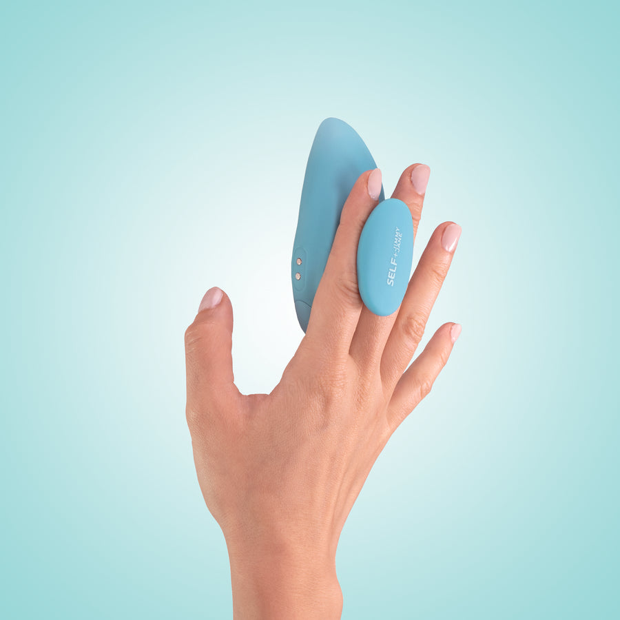 Self + Jimmyjane vibrating massager with finger grip in light blue in models hand